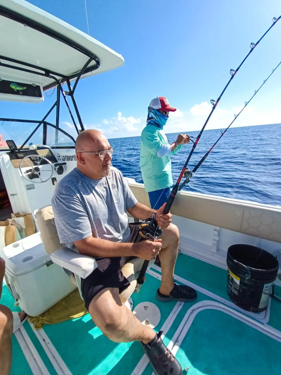 Angler fishing with a rod on board